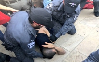 Israeli forces attack and beat one of the protestors before arresting him. Al-Haq © 14 May 2018, Jerusalem.