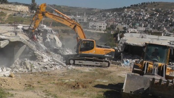 Israeli_bulldozers_demolishing_houses_near_al-Aroub