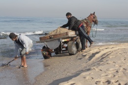 Collecting sand from the Gaza beach. Bassam Almohor 2012