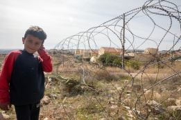 A child standing by Isareli settlement in Um Al-Kheir Village, South Yatta, Hebron. 