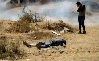 Ahmad Nabi Abu ‘Aqel, killed by the IOF on 20 April 2018, lying injured next to crutches he has had to use since 8 December 2018, following his injury by the IOF. Photo: Yasser Qudih.