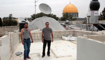 Azzam-and-his-brother-on-the-remains-of-his-demolished-home