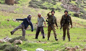 Settlers-from-Itzhar-settlement-throwing-stones-on-Palestinians-with-the-protection-of-Israeli-soldiers
